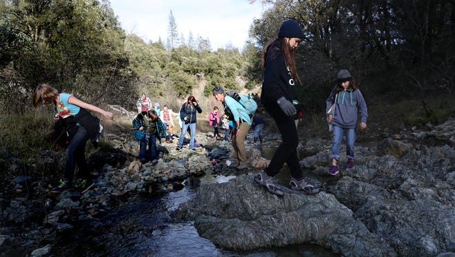 File photo - Kathy Hill, a field instructor at Whiskeytown Environmental School, center, on Monday, Jan. 29, 2018 leads a group of fifth-graders on a hike.