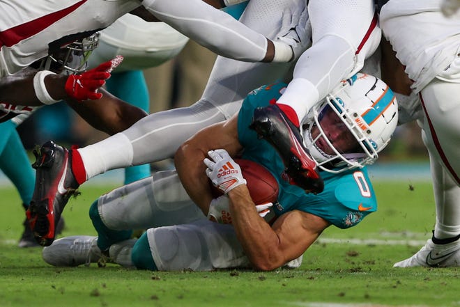 Aug 11: Miami Dolphins wide receiver Braxton Berrios (0) is brought down by Atlanta Falcons linebacker DeAngelo Malone (51) in the second quarter at Hard Rock Stadium.