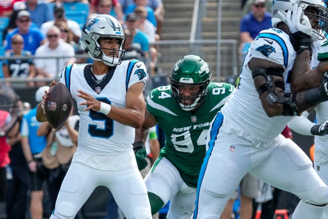 Aug. 12: Carolina Panthers rookie quarterback Bryce Young gets ready to throw while receiving pressure from New York Jets defensive end Solomon Thomas (94) during the first quarter at Bank of America Stadium in Charlotte, North Carolina.