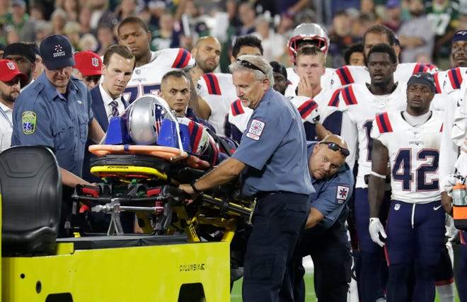 Aug. 19: Teammates look on as New England Patriots cornerback Isaiah Bolden is taken off the field on a stretcher.