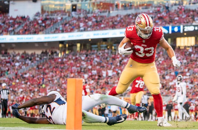 Aug. 19: San Francisco 49ers fullback Jack Colletto (33) scores a touchdown against Denver Broncos safety Delarrin Turner-Yell (32) during the third quarter.