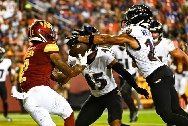 Aug. 21: Baltimore Ravens safety Ar'Darius Washington (29) breaks up the pass intended for Washington Commanders wide receiver Dyami Brown (2) during the first half at FedExField.