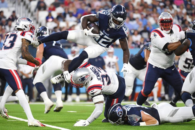 Aug. 25: Tennessee Titans running back Tyjae Spears (32) is tackled by New England Patriots linebacker Anfernee Jennings (33).