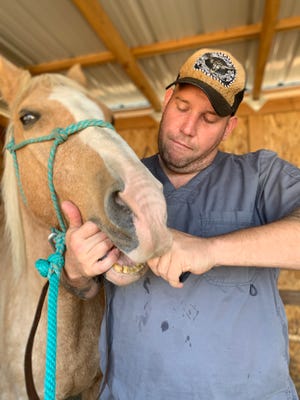 "Say 'aaaahhhh." Veterinarian Keaton Massie of Medford cares for an equine patient. He and his wife Andria opened Massie Mobile Veterinary Services on Nov. 1, 2020.