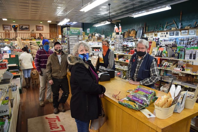 Ron McCloud, proprietor of Dunsmuir Hardware, helps Kelley Brentt as employee Kevin Tynsky waits on customers Doyle Roate and Curtis Smith on the first day the store re-opened on Feb. 8. 2021. The store was closed for more than two months after McCloud contracted COVID-19.