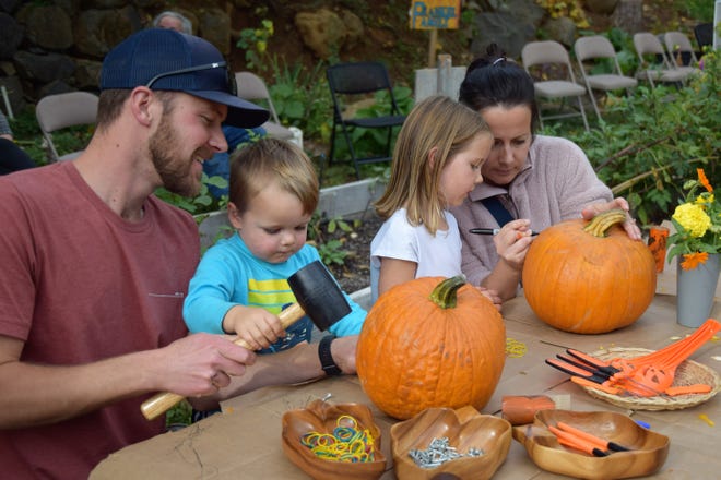 The Massey family from Bend, Oregon enjoy making geo globe pumpkin at the annual Harvest Festival on Friday, Oct. 29, 2021 in Dunsmuir. Luke Massey said, "We heard it would be fun to come to Dunsmuir, but it is so beautiful here as well. Our kids really enjoyed themselves."